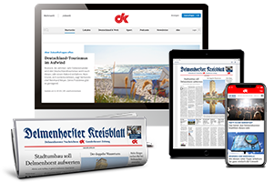 MacBook, iPad und iPhone mit Website dk-online.de und Zeitungsrolle